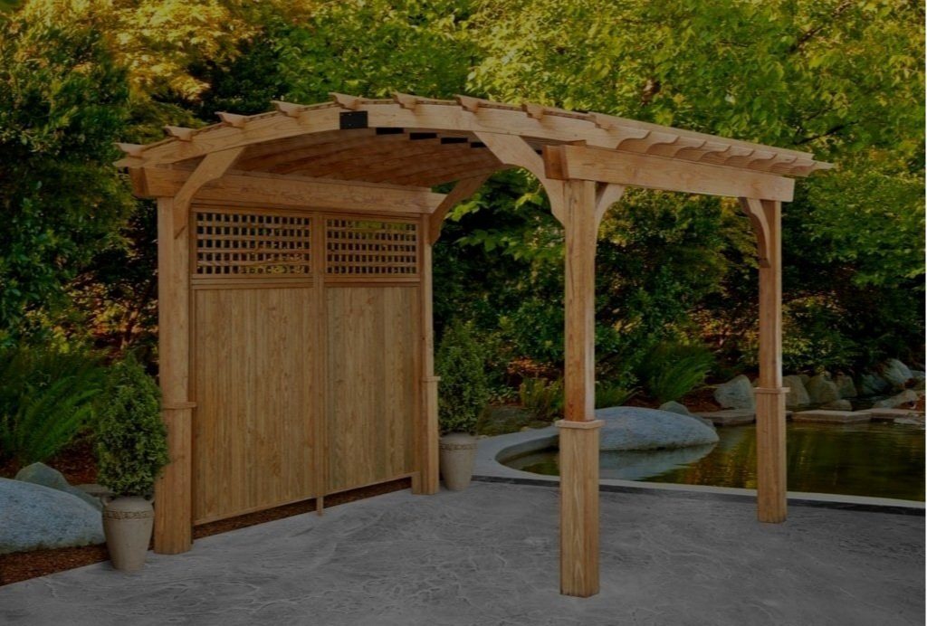 A cedar pergola with a lattice screen panel over a paved area.