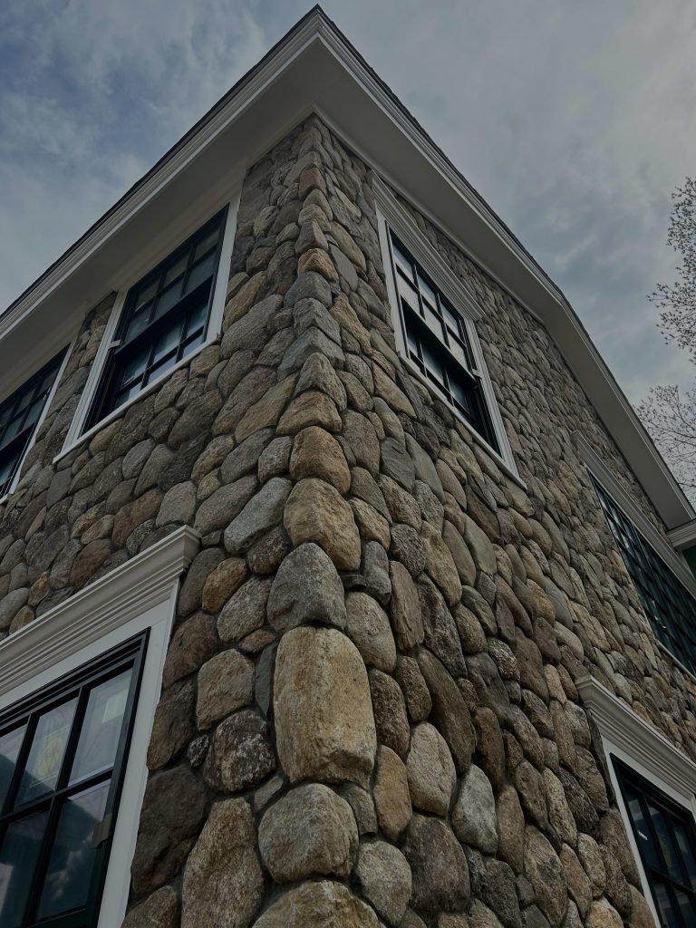 A close view of a dry laid fieldstone wall face.